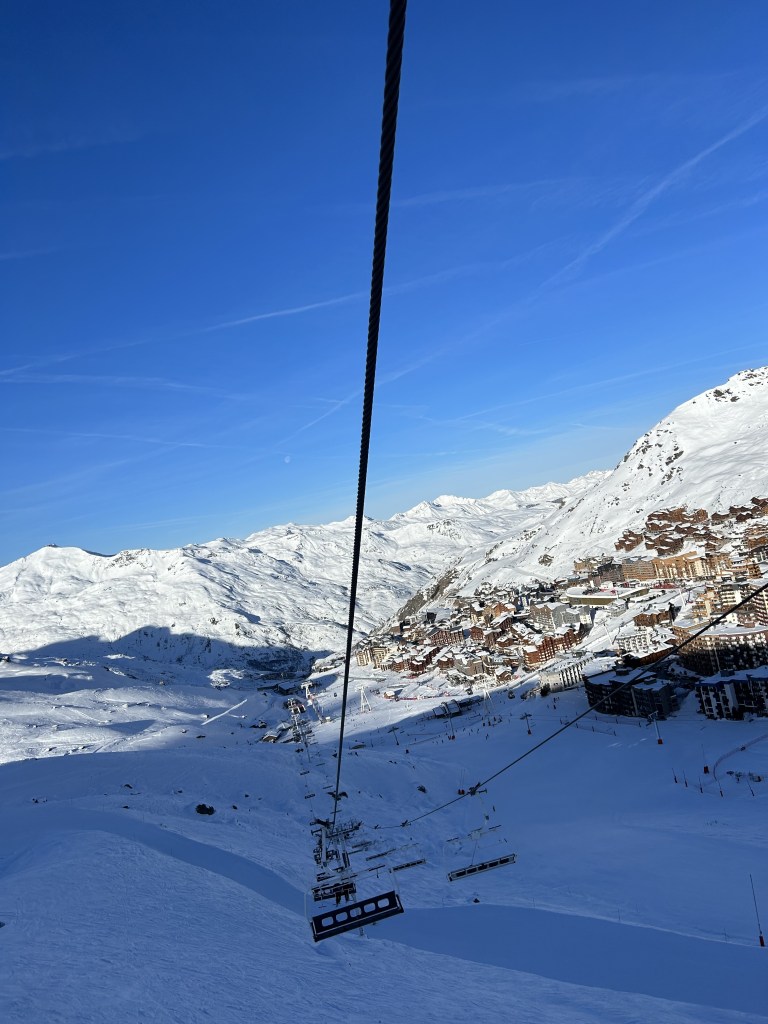 The view down the ski lift of a French alp ski slope.